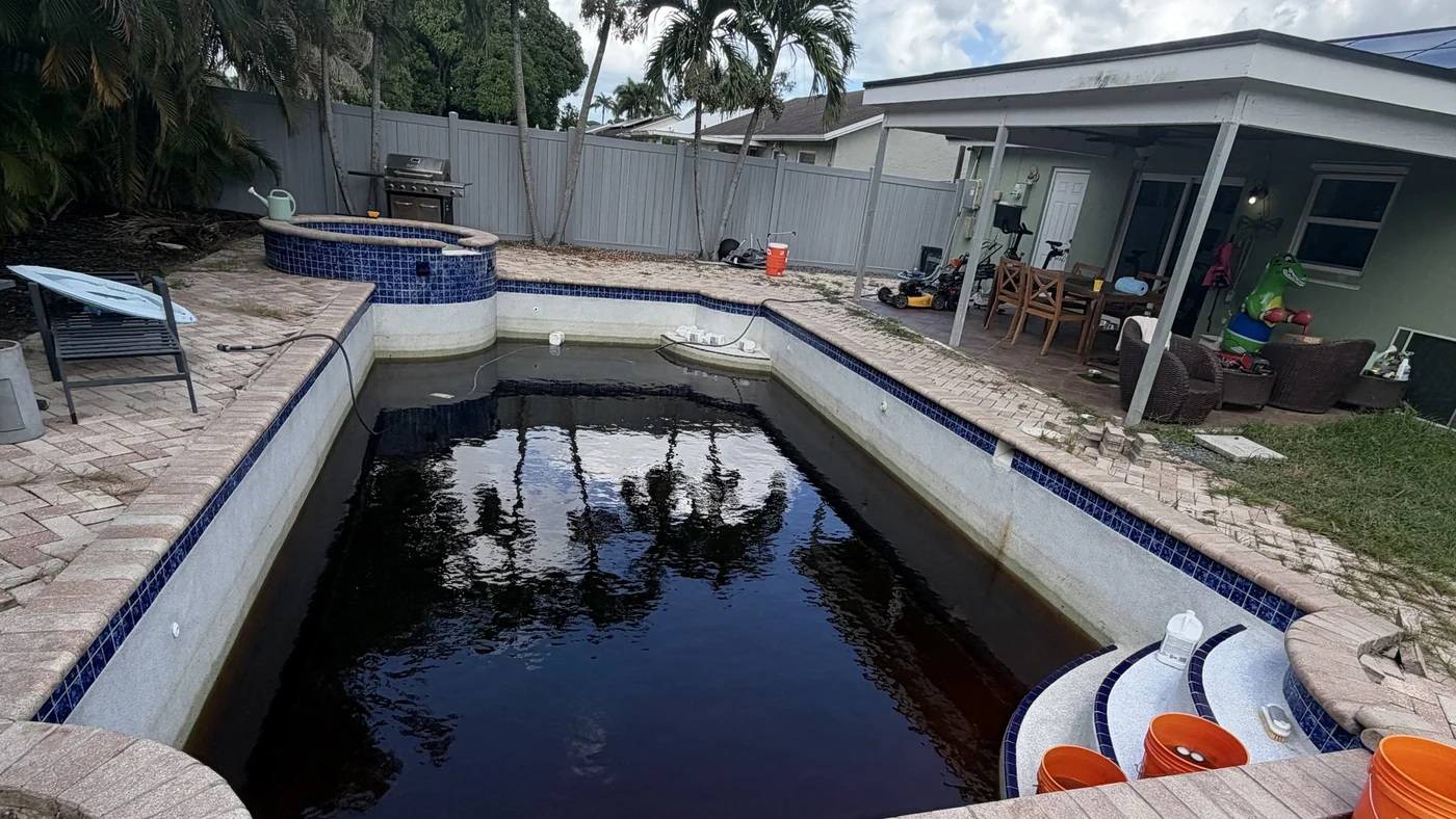The existing pool, raised spa and brick paver deck today, before demolition
